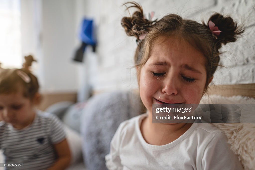 Sad girl crying in her room