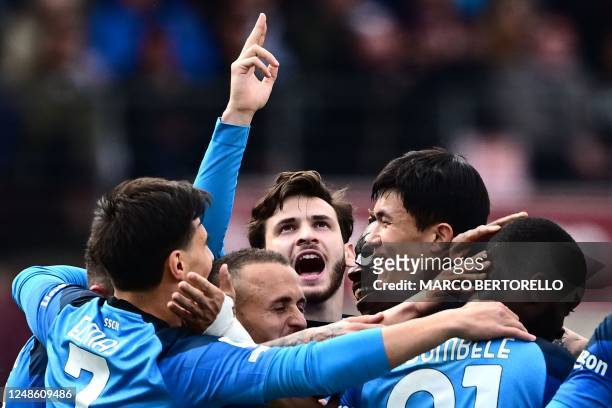 Napoli's French midfielder Tanguy Ndombele celebrates with his teammates and Napoli's Georgian forward Khvicha Kvaratskhelia after scoring his side's...