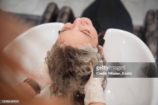 hairdresser washing customer hair, reopening business after coronavirus, covid-19 quarantine - hair growth stock pictures, royalty-free photos & images