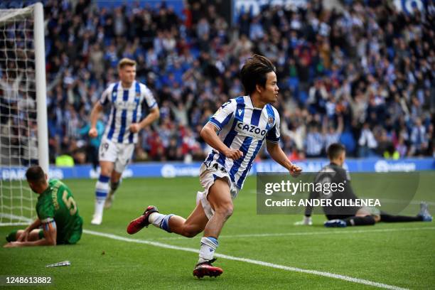 Real Sociedad's Japanese forward Takefusa Kubo celebrates after scoring his team's first goal during the Spanish league football match between Real...