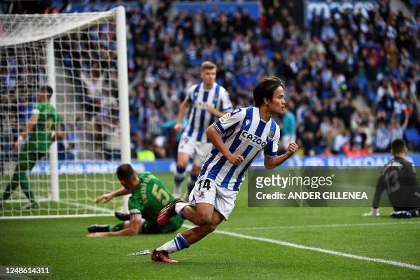 Real Sociedad's Japanese forward Takefusa Kubo celebrates after scoring his team's first goal during the Spanish league football match between Real...