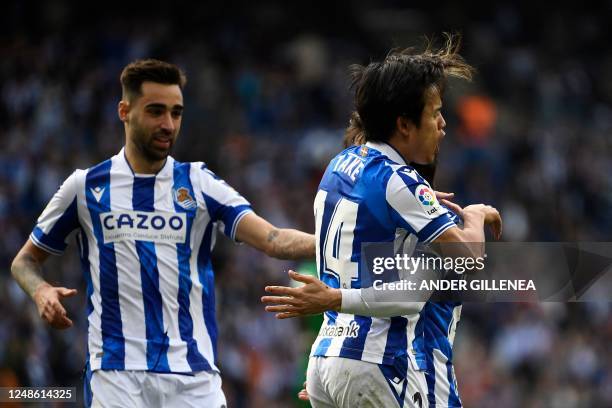 Real Sociedad's Japanese forward Takefusa Kubo celebrates with Real Sociedad's Spanish midfielder Brais Mendez and Real Sociedad's Spanish midfielder...