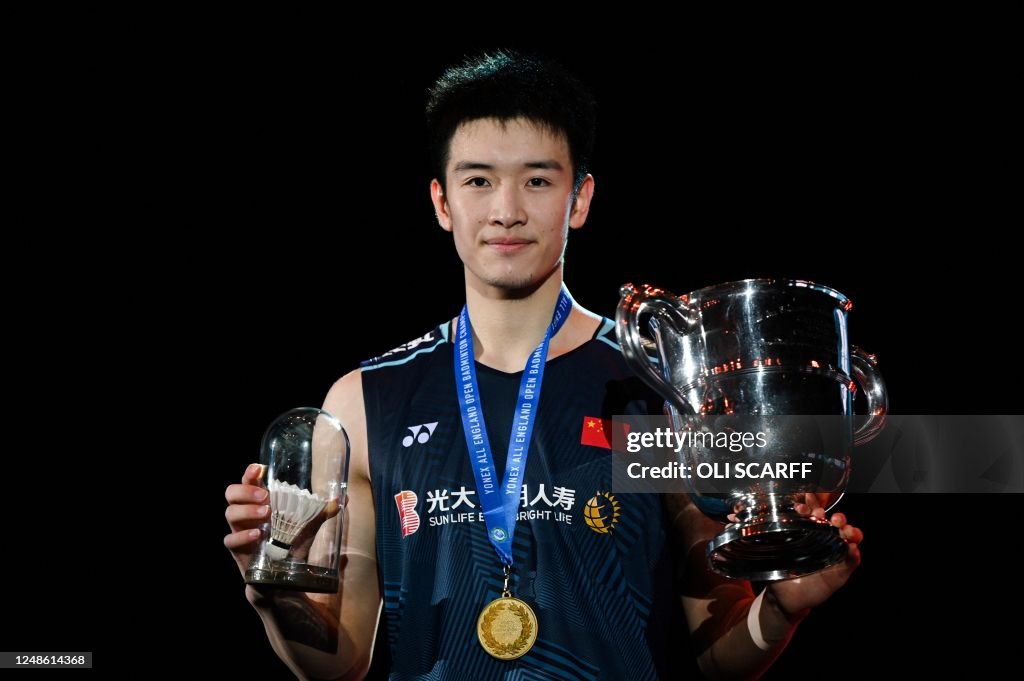 Winner China's Li Shi Feng celebrates with the gold medal and trophy ...