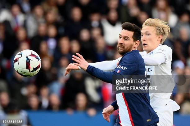 Paris Saint-Germain's Argentine forward Lionel Messi fights for the ball with Rennes' Norwegian defender Birger Meling during the French L1 football...