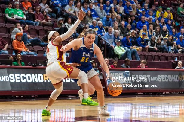 Paige Meyer of the South Dakota Jackrabbits gets around Kayla Williams of the USC Trojans during the first round of the 2023 NCAA Women's Basketball...