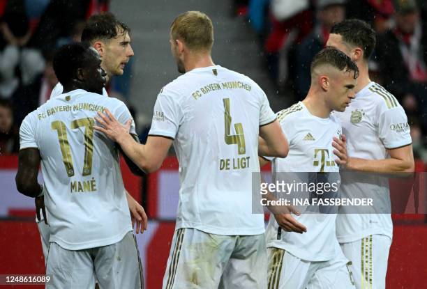 Bayern Munich's German midfielder Joshua Kimmich celebrates with teammates after scoring the 0-1 goal during the German first division Bundesliga...