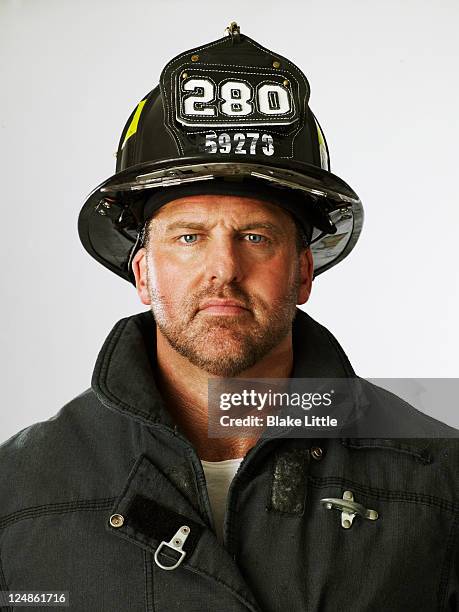 fireman close up - firefighter's helmet stock-fotos und bilder