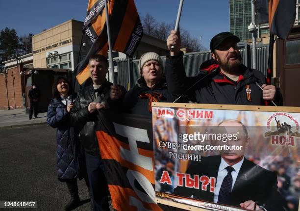 Activists of pro-Putin's National Liberation Movement hold a poster with picture of President Putin that reads:"We are with him for sovereignty of...