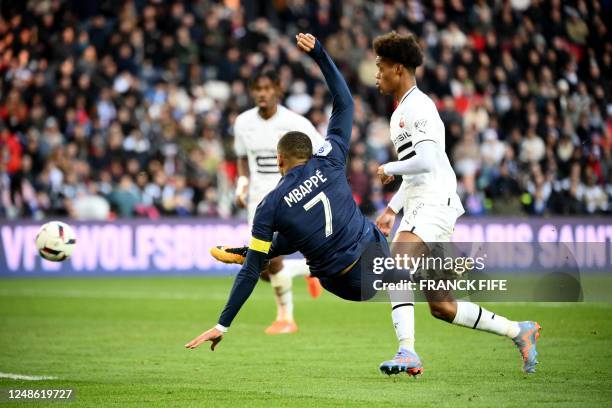 Paris Saint-Germain's French forward Kylian Mbappe shoots the ball during the French L1 football match between Paris Saint-Germain and Stade Rennais...