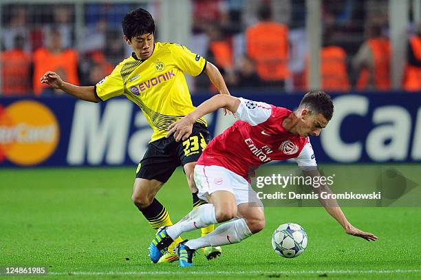 Shinji Kagawa of Dortmund and Laurent Koscielny of Arsenal battle for the ball during the UEFA Champions League Group F match between Borussia...