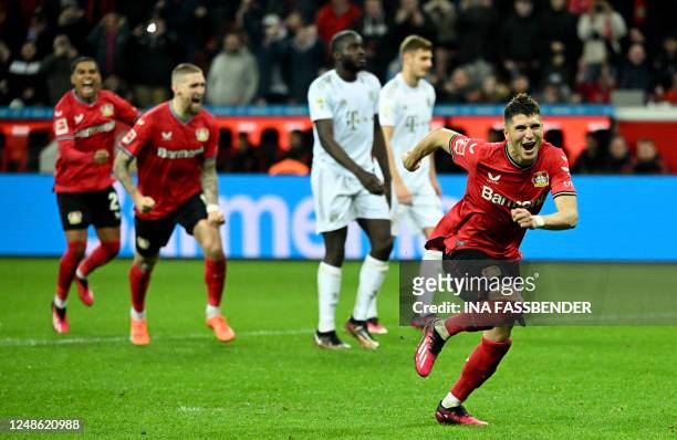 Leverkusen's Argentinian midfielder Exequiel Palacios celebrates after scoring the 2-1 penalty goal during the German first division Bundesliga...