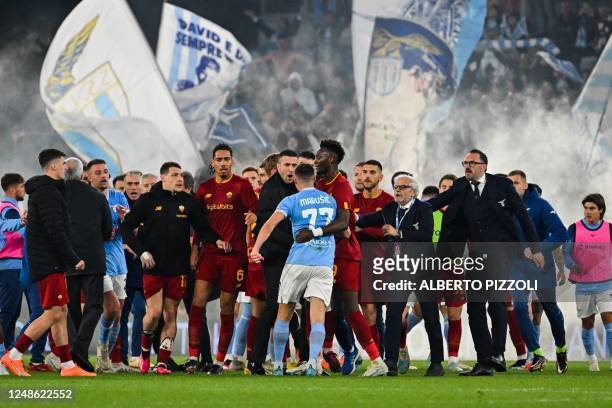 Players skirmish at the end of the Italian Serie A football match between Lazio and AS Rome on March 19, 2023 at the Olympic stadium in Rome.