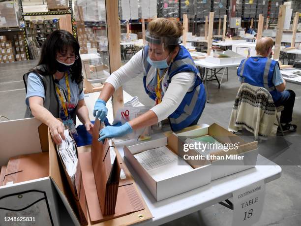 Ann-Marie Gomes and Juanita Thompson count and verify mail ballots at the Clark County Election Department, which is serving as both a primary...