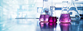 purple glass flask in blue light research chemistry science lab