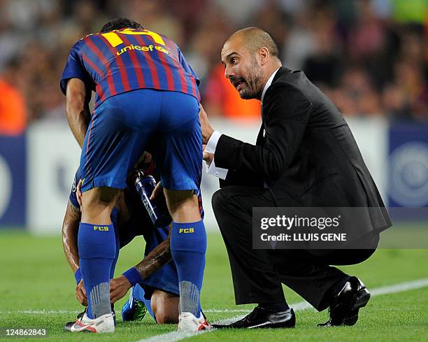 Barcelona's coach Josep Guardiola gives instructions to Barcelona's Argentinian midfielder Javier Mascherano and Barcelona's Brazilian defender...