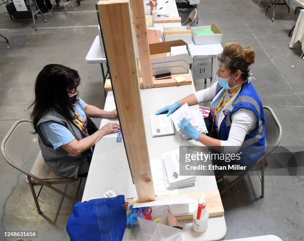 Ann-Marie Gomes and Juanita Thompson count and verify mail ballots at the Clark County Election Department, which is serving as both a primary...