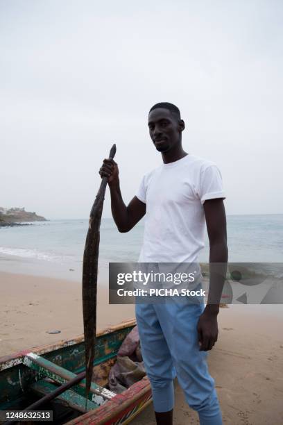 fisherman standing - senegal fisherman stock pictures, royalty-free photos & images