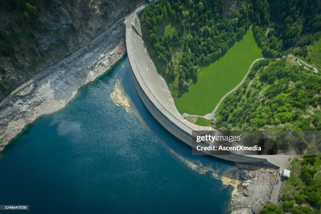 Aerial view of bridge on large dam in Swiss Alps
