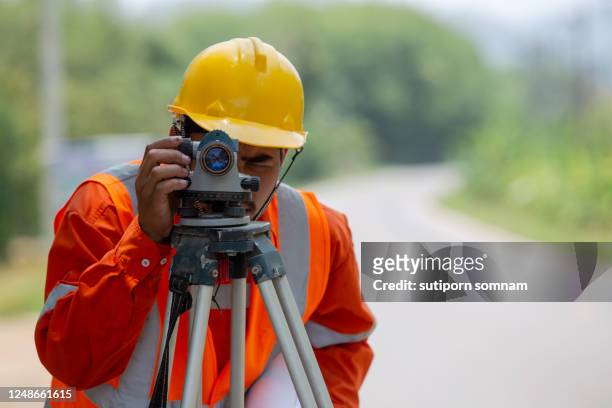 close-up of the engineer, surveying the road construction site - wind instruments stock-fotos und bilder