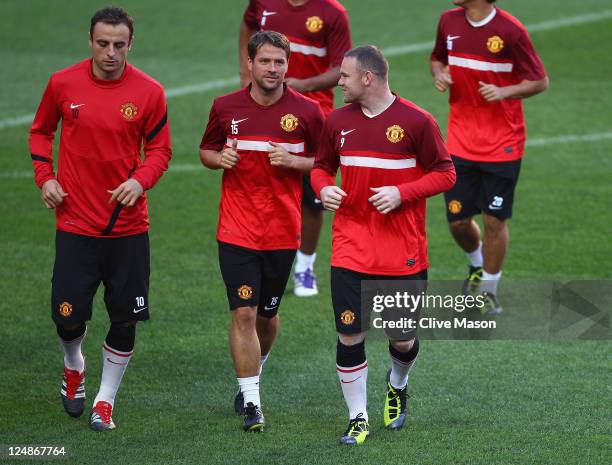 Wayne Rooney of Manchester United talks with Michael Owen of Manchester United during a training session ahead of the UEFA Champions League Group C...