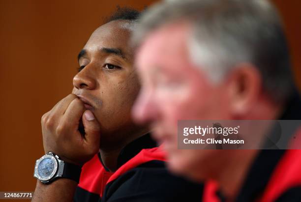 Anderson of Manchester United looks at manager Sir Alex Ferguson during a press conference ahead of the UEFA Champions League Group C match between...