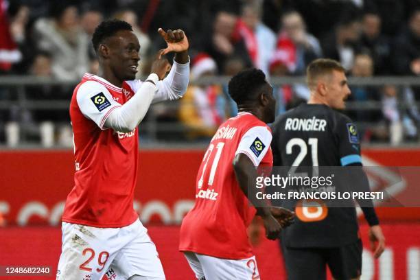 Reims' English forward Folarin Balogun celebrates scoring his team's first goal with teammates during the French L1 football match between Stade de...