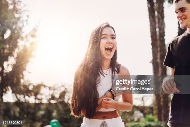 young teen couple laughing outdoor and having fun - couple in surprise stock pictures, royalty-free photos & images