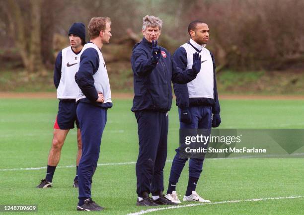 Arsene Wenger the Arsenal Manager chats to Thierry Henry and Dennis Bergkamp during an Arsenal training session on March 23, 2004 in St. Albans,...