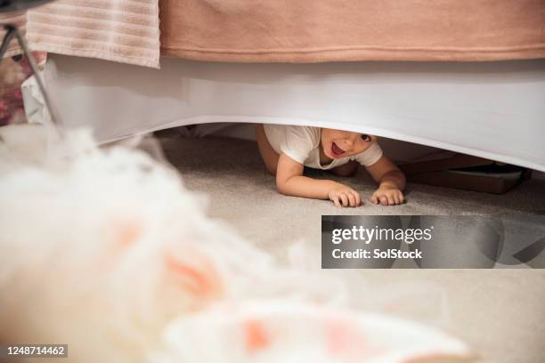 hiding under the bed - hide and seek stock pictures, royalty-free photos & images