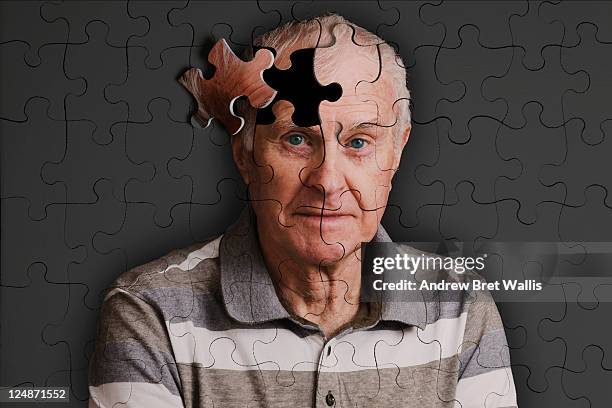 jigsaw puzzle, of senior man, falling apart - alzheimer's stock-fotos und bilder