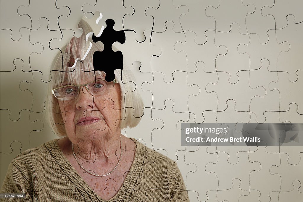 Jigsaw puzzle, of a senior woman, falling apart