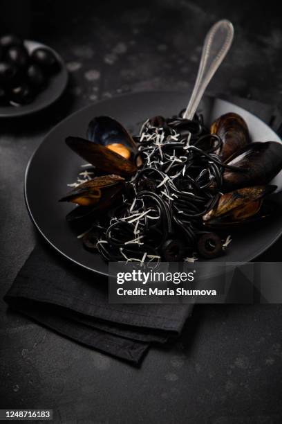 black italian pasta cooked with mussels - dark fruit ink stock pictures, royalty-free photos & images