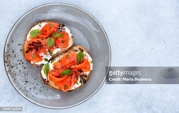 tasty sandwiches with cream cheese and smoked salmon - rökt lax bildbanksfoton och bilder