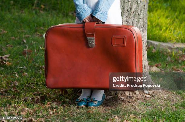 closeup image of little child holding suitcase with space for text - weeshuis stockfoto's en -beelden