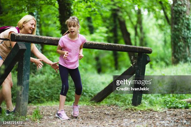 mother and daughter having fun together in the woods - cerebral palsy stock pictures, royalty-free photos & images