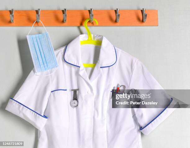 doctor? / nurse uniform on coat rack - medical scrubs hanger stock pictures, royalty-free photos & images