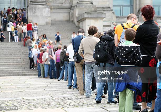 waiting patiently - queue of people stockfoto's en -beelden