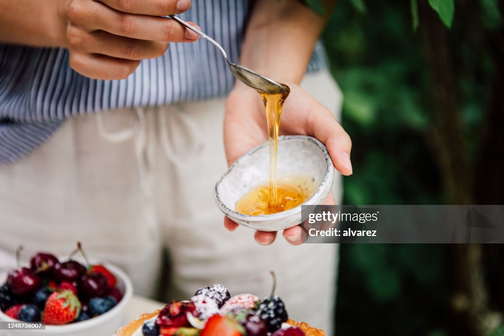Close-up of a woman preparing cake for breakfast