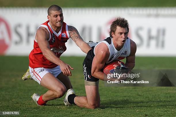 Daniel Pratt of the Roosters marks the ball in front of Paul Bower of the Bullants during the VFL Semi Final match between North Ballarat and...