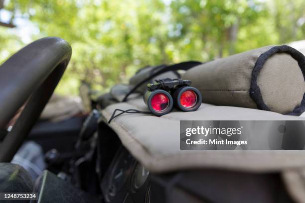 binoculars on the dashboard of a safari jeep. - wildlife reserve stock pictures, royalty-free photos & images