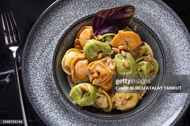 tri-color tortellini - tortellini stock pictures, royalty-free photos & images