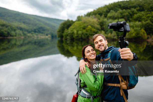 couple in love taking selfie so they can remember this moment forever - selfie stick stock pictures, royalty-free photos & images