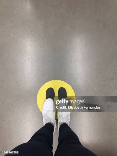 low section of woman standing on floor markings for social distancing - marquer son territoire photos et images de collection