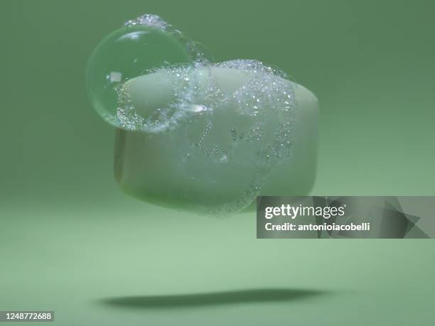 close-up of a bar of soap covered in soap suds - seife stock-fotos und bilder