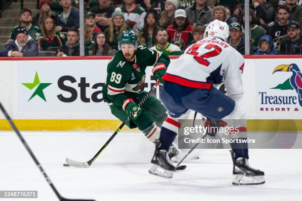 Minnesota Wild center Frederick Gaudreau skates with the puck while being defended by Washington Capitals defenseman Martin Fehervary during the NHL...