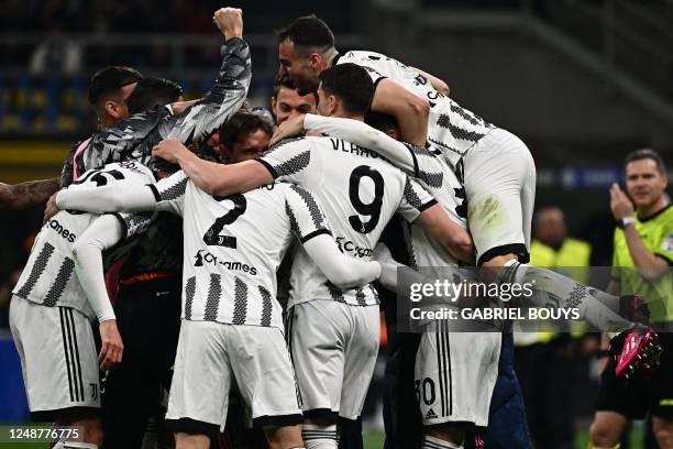 Inter players celebrate after opening the scoring during the Italian Serie A football match between Inter and Juventus on March 19, 2023 at the...