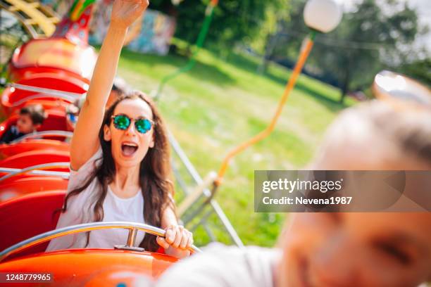 young woman screaming on a rollercoaster - young woman screaming on a rollercoaster stock pictures, royalty-free photos & images