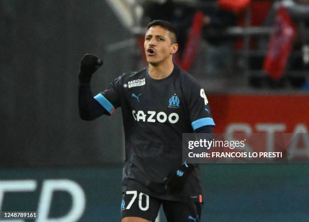 Marseille's Chilean forward Alexis Sanchez celebrates after scoring a goal during the French L1 football match between Stade de Reims and Olympique...