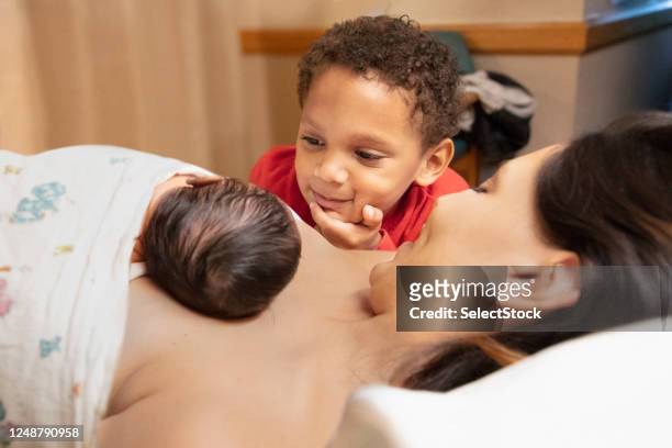 mother and son admiring newborn baby at hospital - baby blanket stock pictures, royalty-free photos & images