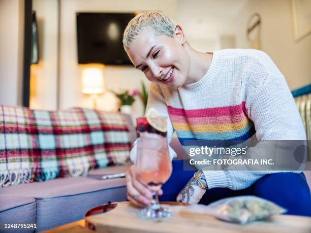 young woman having cocktail drink at home - cocktail party home stock pictures, royalty-free photos & images